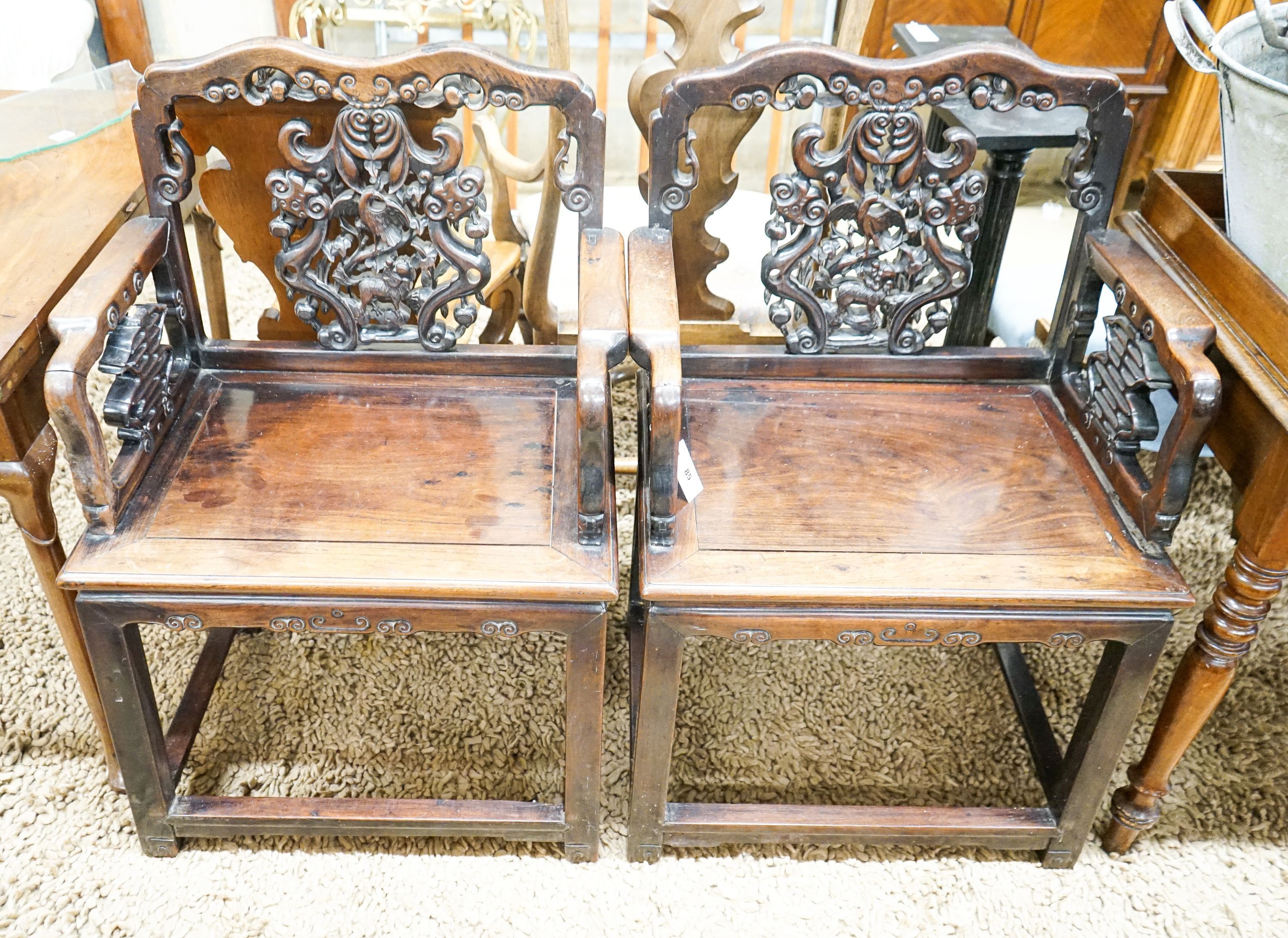 A pair of Chinese carved hongmu elbow chairs (a.f.), width 65cm, depth 48cm, height 96cm